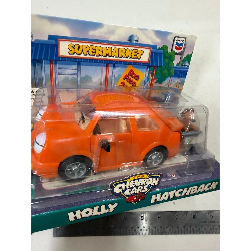 The Chevron Cars Holly Hatchback Orange Toy Car with Dog and Shopping Cart 1997